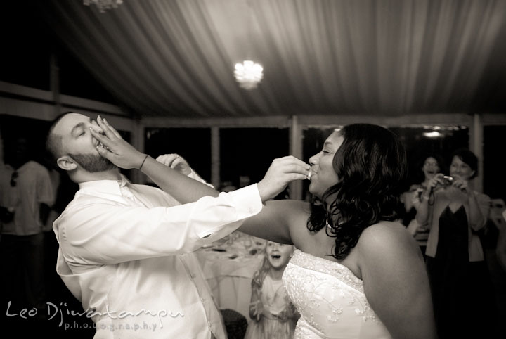 Bride and groom smashing cake to each others' faces. Kitty Knight House Georgetown Maryland wedding photos by photographers of Leo Dj Photography.