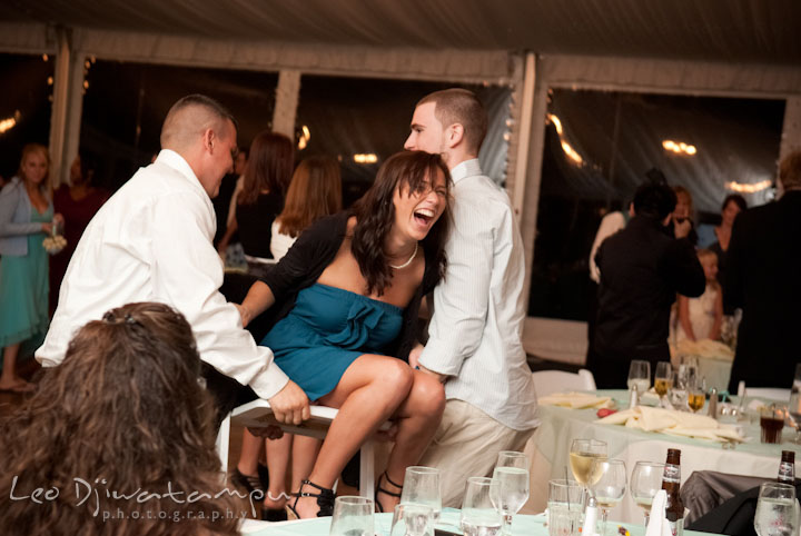 Two guys lift up guest girl on chair. Kitty Knight House Georgetown Maryland wedding photos by photographers of Leo Dj Photography.