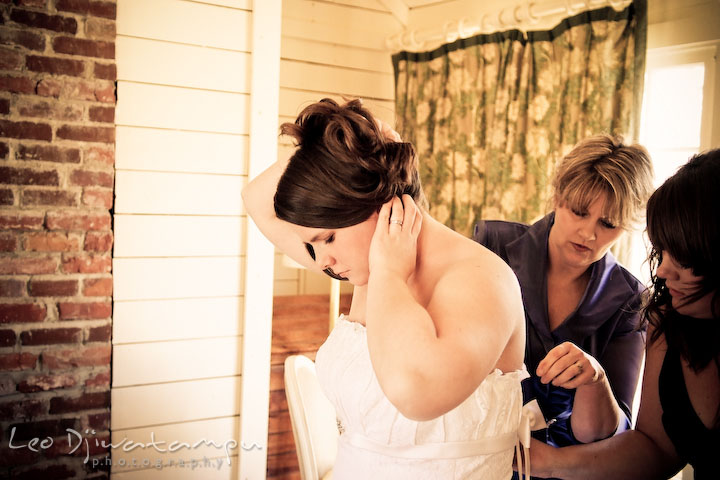 bride putting dress with mother and maid of honor. Clifton Inn Charlottesville VA Destination Wedding Photographer