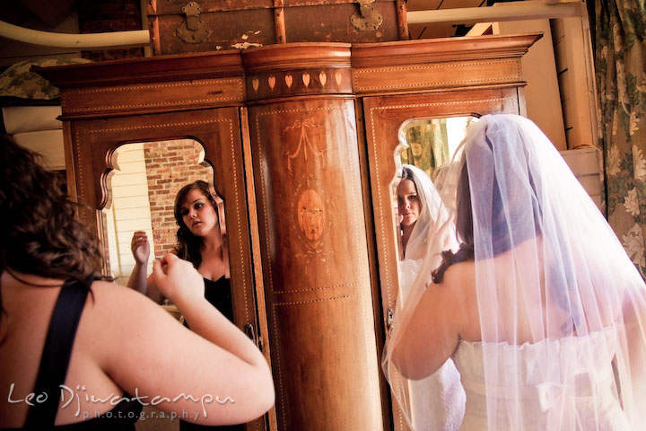 bride and maid of honor looking at mirror checking make up. Clifton Inn Charlottesville VA Destination Wedding Photographer