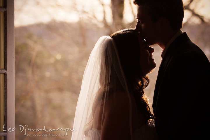 groom kissed bride's forehead, silhouette. Clifton Inn Charlottesville VA Destination Wedding Photographer