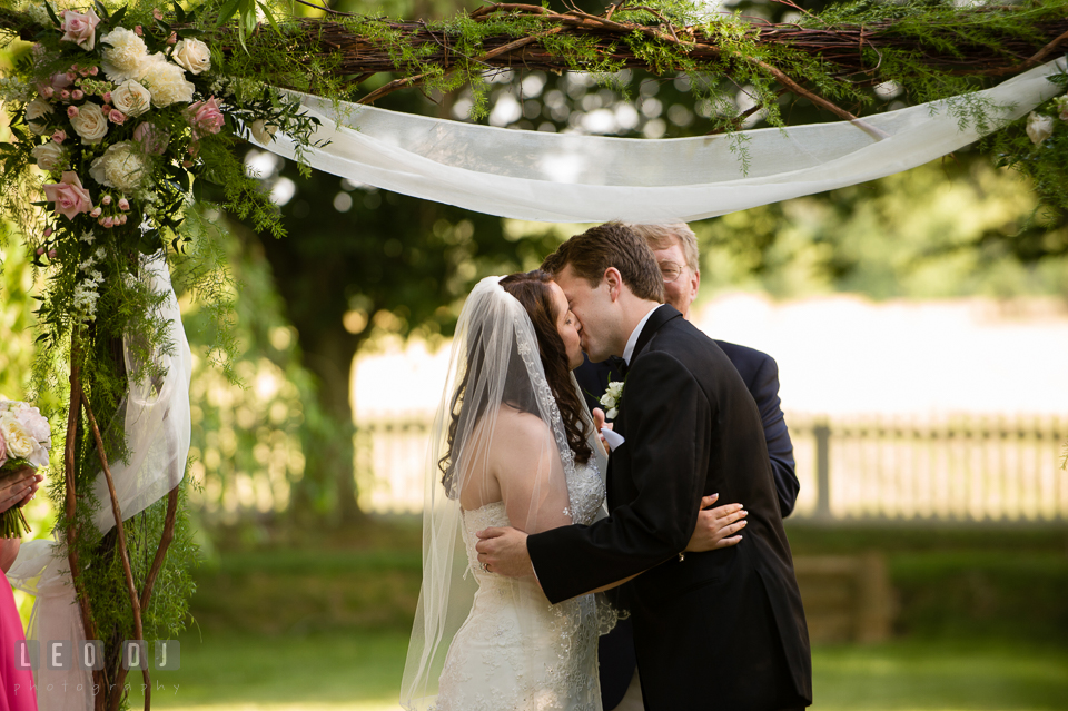 Groom and Bride's first kiss during the ceremony. Aspen Wye River Conference Centers wedding at Queenstown Maryland, by wedding photographers of Leo Dj Photography. http://leodjphoto.com