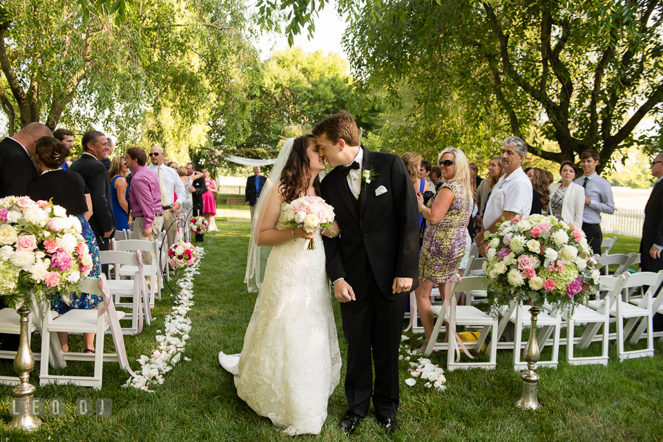 The Bride and Groom kissing during recessional after their wedding ceremony. Aspen Wye River Conference Centers wedding at Queenstown Maryland, by wedding photographers of Leo Dj Photography. http://leodjphoto.com