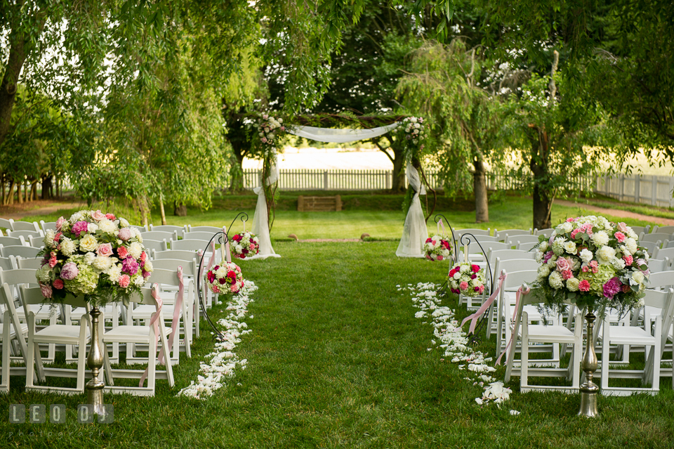 The beautiful setting for wedding ceremony with flower decors from florist Monteray Farms. Aspen Wye River Conference Centers wedding at Queenstown Maryland, by wedding photographers of Leo Dj Photography. http://leodjphoto.com