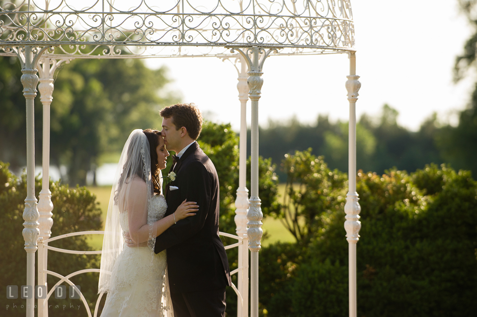 Groom kissing Bride under the pergola. Aspen Wye River Conference Centers wedding at Queenstown Maryland, by wedding photographers of Leo Dj Photography. http://leodjphoto.com