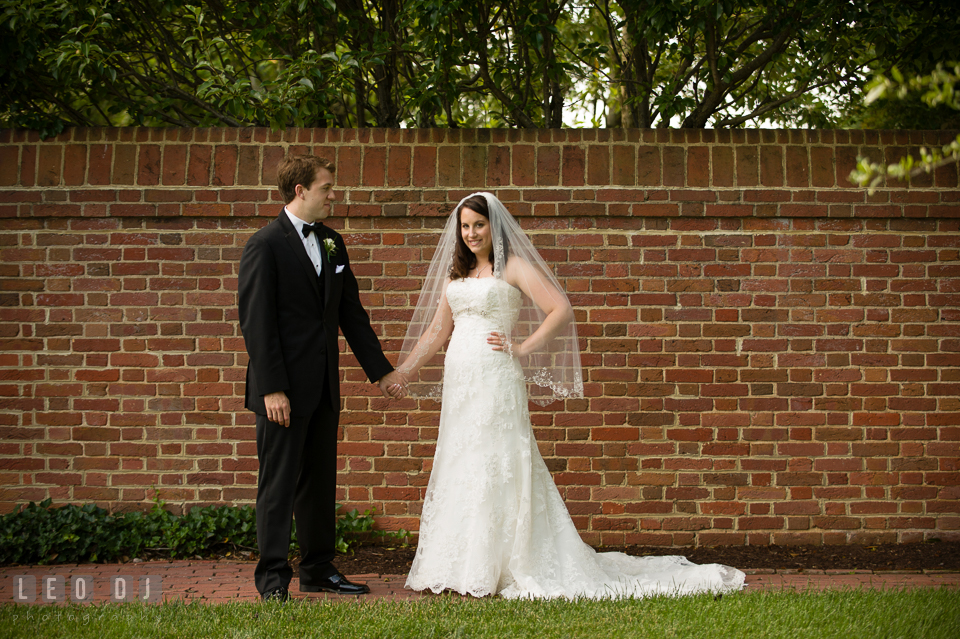 The Bride and Groom holding hands posing for pictures. Aspen Wye River Conference Centers wedding at Queenstown Maryland, by wedding photographers of Leo Dj Photography. http://leodjphoto.com