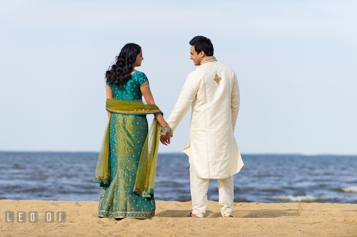 Engaged couple holding hands on the beach. Indian pre-wedding or engagement photo session at Eastern Shore beach, Maryland, by wedding photographers of Leo Dj Photography.