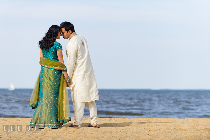 Engaged guy and girl almost kissed on the beach. Indian pre-wedding or engagement photo session at Eastern Shore beach, Maryland, by wedding photographers of Leo Dj Photography.