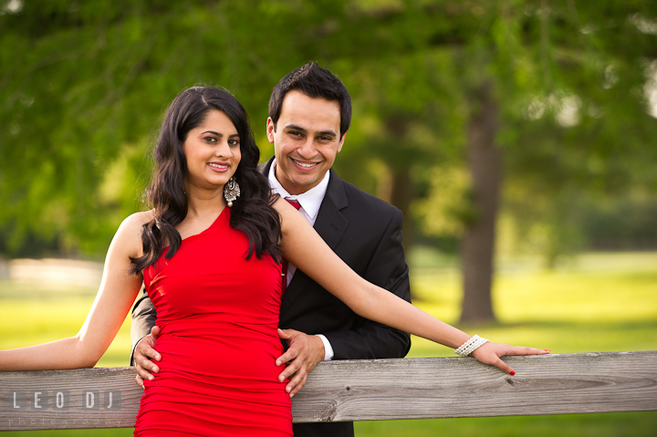 Engaged girl and her fiancé posing and smiling. Indian pre-wedding or engagement photo session at Eastern Shore beach, Maryland, by wedding photographers of Leo Dj Photography.