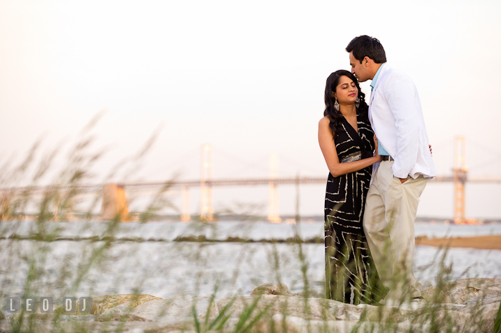 Engaged guy kissed his fiancée's forehead. Indian pre-wedding or engagement photo session at Eastern Shore beach, Maryland, by wedding photographers of Leo Dj Photography.