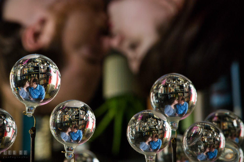 Home Residence Baltimore Maryland reflection of engaged couple almost kissing in bulbs photo by Leo Dj Photography.