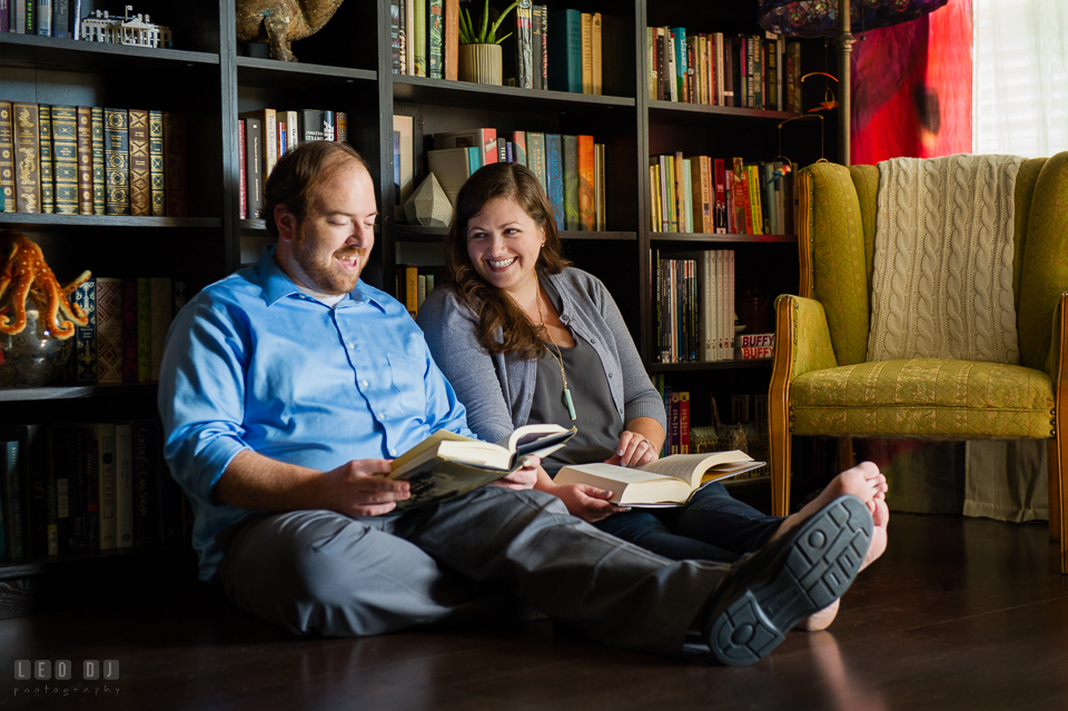 Condo Residence Baltimore Maryland engaged couple reading together in library photo by Leo Dj Photography.