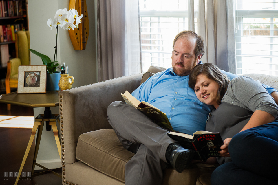 Condo Residence Baltimore Maryland engaged girl cuddling and reading together with fiance photo by Leo Dj Photography.