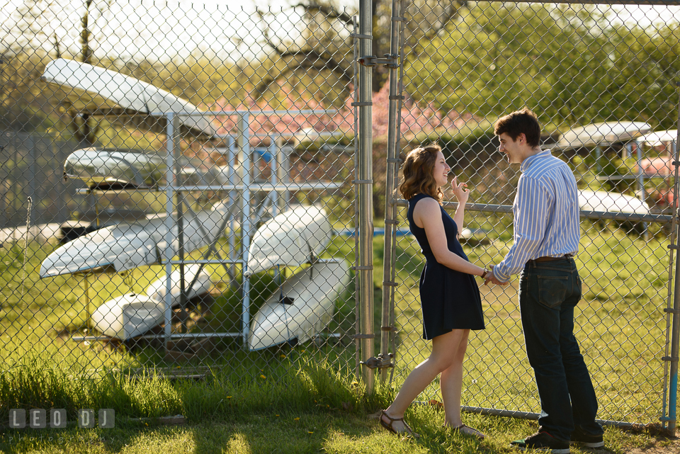 Baltimore Rowing Club Maryland engaged couple hanging by boat storage photo by Leo Dj Photography.