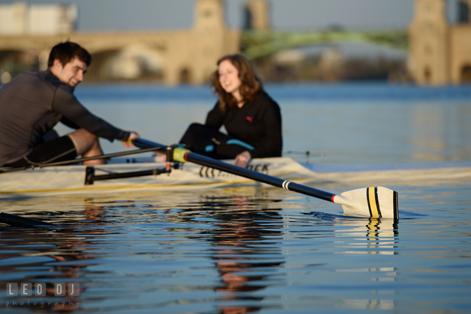 Baltimore Rowing Club Maryland engaged man rowing boat with fiancée laughing photo by Leo Dj Photography.