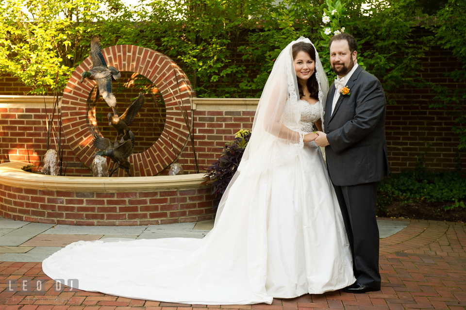 Bride and Groom posing together by the water fountain. The Tidewater Inn wedding, Easton, Eastern Shore, Maryland, by wedding photographers of Leo Dj Photography. http://leodjphoto.com