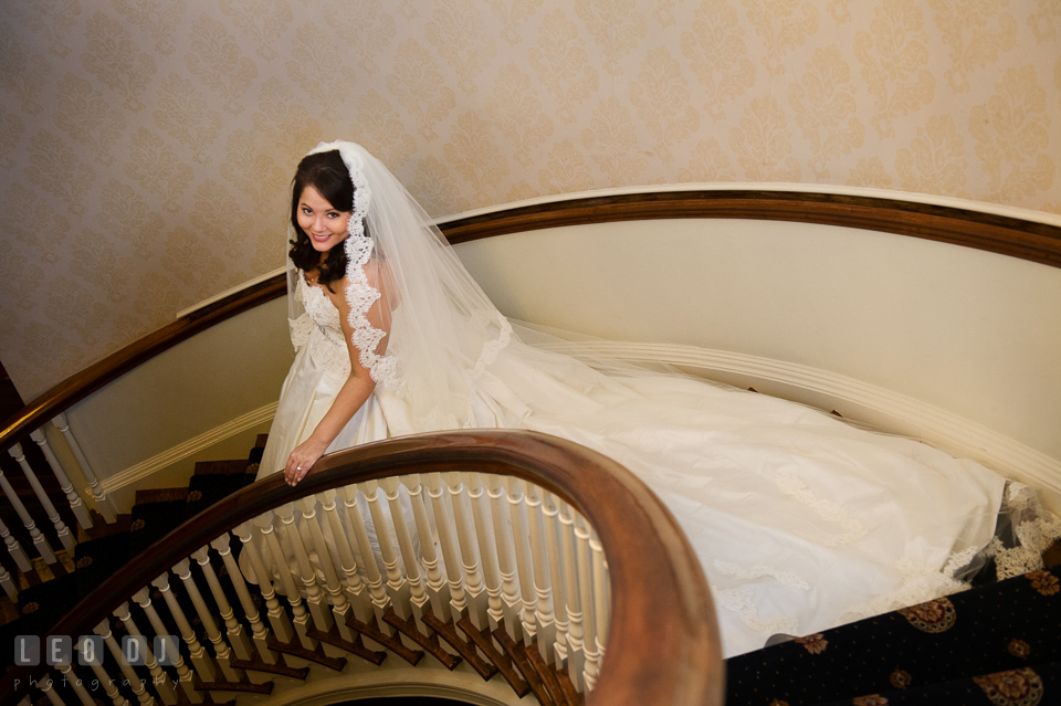 Bride with her long train and cathedral veil walking down the spiral staircase. The Tidewater Inn wedding, Easton, Eastern Shore, Maryland, by wedding photographers of Leo Dj Photography. http://leodjphoto.com