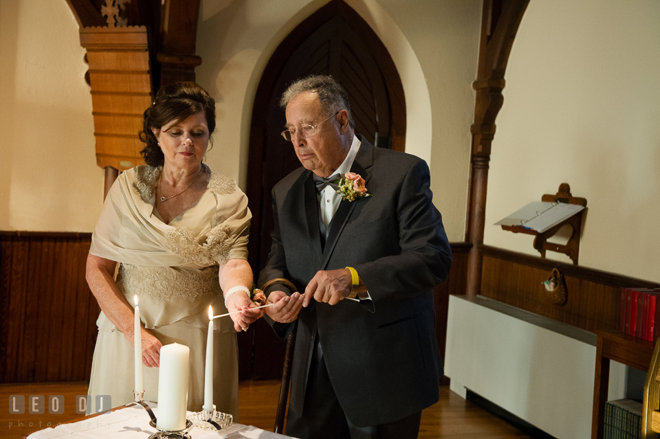 Mother of the Bride and Father of the Groom lighting the unity candles. The Trinity Cathedral wedding, Easton, Eastern Shore, Maryland, by wedding photographers of Leo Dj Photography. http://leodjphoto.com