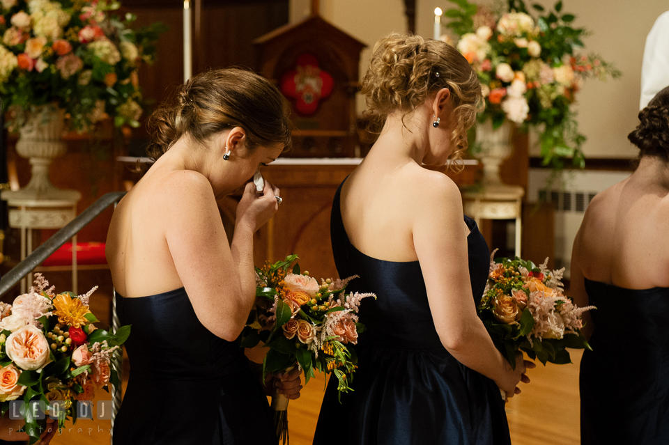 Bridesmaid wiping of her emotional tear during the ceremony. The Trinity Cathedral wedding, Easton, Eastern Shore, Maryland, by wedding photographers of Leo Dj Photography. http://leodjphoto.com