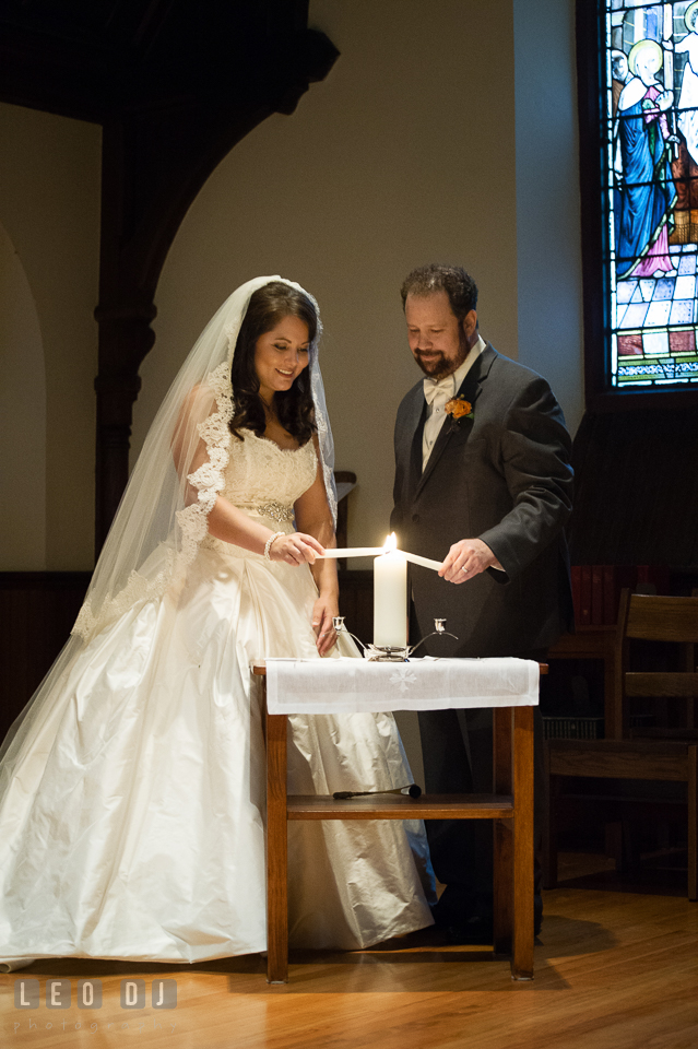 Bride and Groom lighting up the unity candle. The Trinity Cathedral wedding, Easton, Eastern Shore, Maryland, by wedding photographers of Leo Dj Photography. http://leodjphoto.com