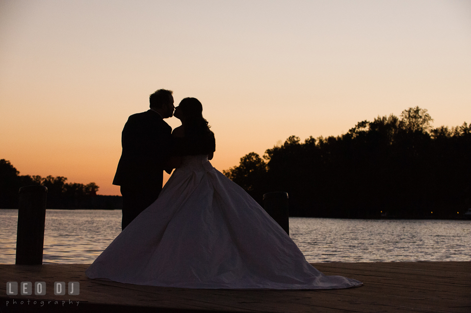 Bride and Groom kissing by the water during sunset. The Tidewater Inn wedding, Easton, Eastern Shore, Maryland, by wedding photographers of Leo Dj Photography. http://leodjphoto.com