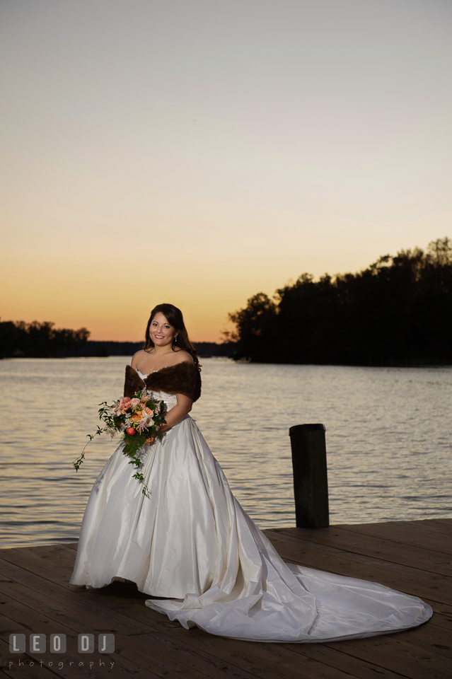 Bride posing with her bouquet by the water during sunset. The Tidewater Inn wedding, Easton, Eastern Shore, Maryland, by wedding photographers of Leo Dj Photography. http://leodjphoto.com