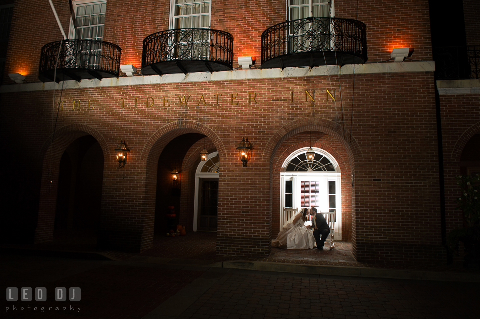 Bride and Groom on the rocking chairs in front of the hotel kissing. The Tidewater Inn wedding, Easton, Eastern Shore, Maryland, by wedding photographers of Leo Dj Photography. http://leodjphoto.com