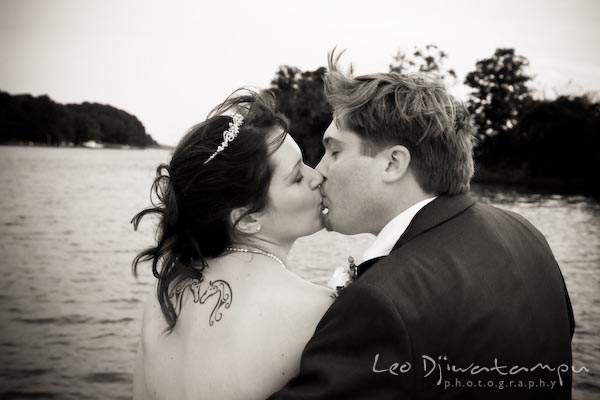 bride with tattoo kissing groom on boat by water annapolis kent island maryland wedding photography photographers