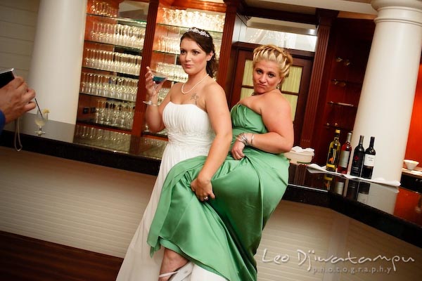 bridesmaid dance with bride lifting leg. Kent Manor Inn Wedding Photography Kent Island MD Photographer