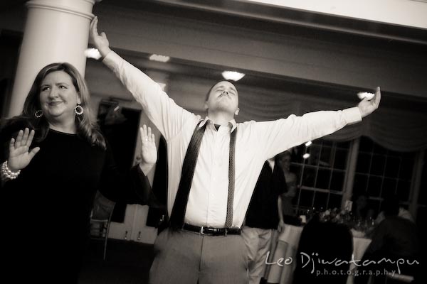 guest raising arms on dance floor. Kent Manor Inn Wedding Photography Kent Island MD Photographer