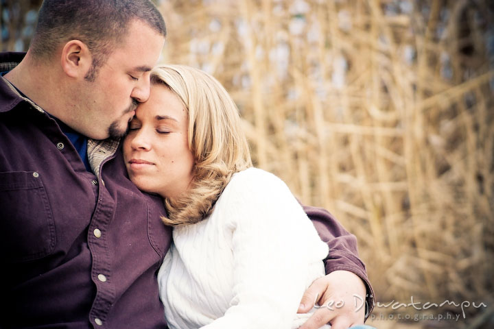 guy kiss girl on forehead, engaged couple. Engagement Photographer Matapeake Beach, Chesapeake Bay