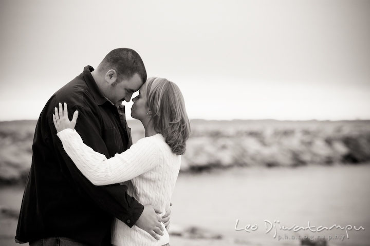 black and white picture of engaged couple hugging, guy, girl, fiancee. Engagement Photographer Matapeake Beach, Chesapeake Bay