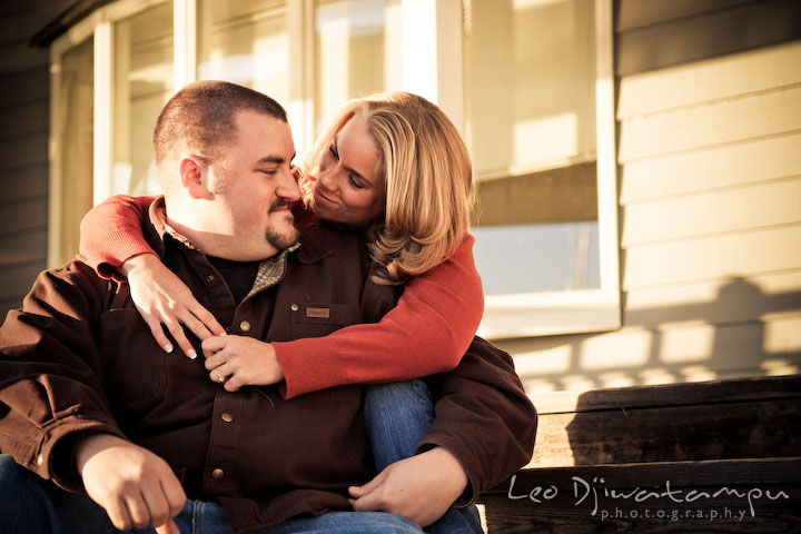 engaged girl hugged her fiancee guy, smiling. Engagement Photographer Matapeake Beach, Chesapeake Bay