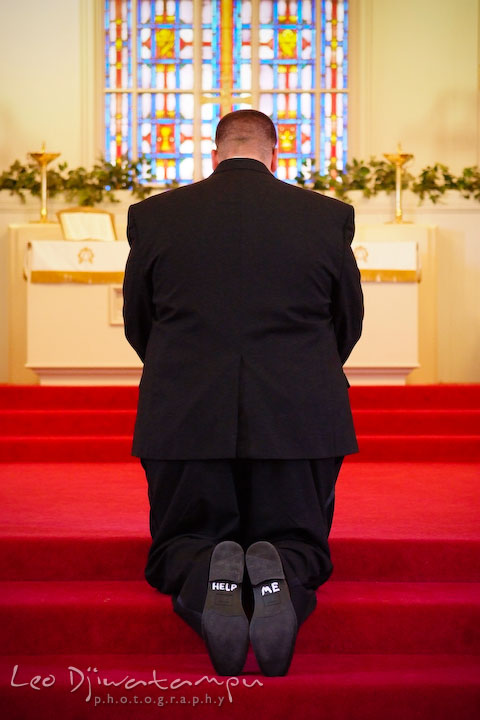 Groom praying in front of the altar. Kent Island Methodist Church KIUMC Wedding Photographer Maryland