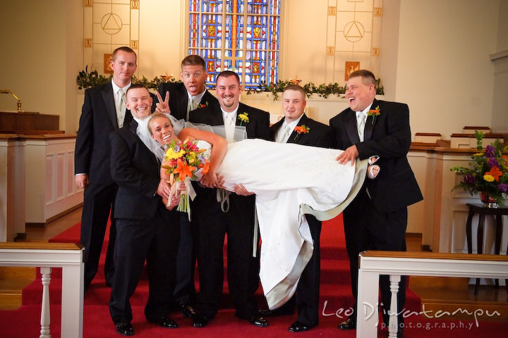 Groom, best man, and groomsman lifting up bride. Kent Island Methodist Church KIUMC Wedding Photographer Maryland