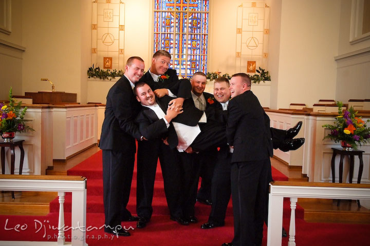 Best man and groomsman succesfully lift up groom. Kent Island Methodist Church KIUMC Wedding Photographer Maryland