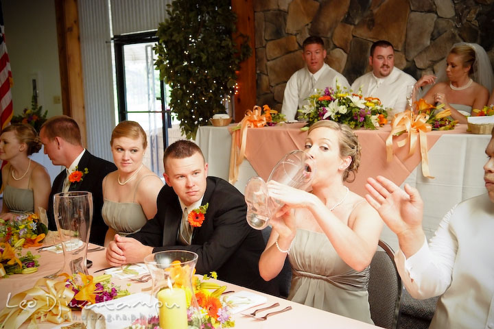 bridesmaid at bridal party table trying to drink from das boot beer glass. Kent Island Flowers MD American Legion Wedding Photographer