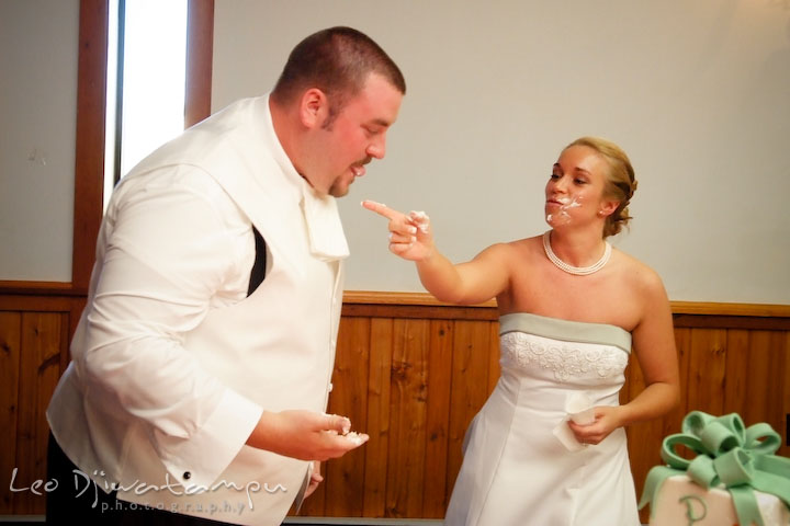 Bride laughing at groom's icing mess on his cheek. Kent Island Flowers MD American Legion Wedding Photographer