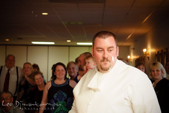 Groom got some icing on his face. Kent Island Flowers MD American Legion Wedding Photographer
