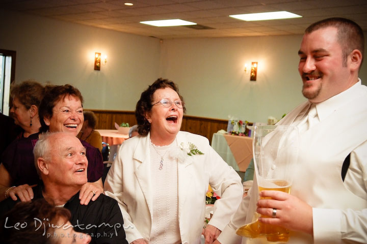 Grandmother and other guests laughing with groom. Kent Island Flowers MD American Legion Wedding Photographer
