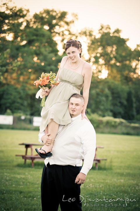 Wife bridesmaid sits on husband groomsman shoulder. Kent Island Flowers MD American Legion Wedding Photographer