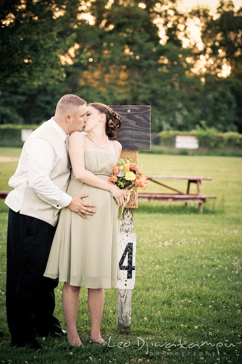 Husband groomsman kissing bridesmaid wife. Kent Island Flowers MD American Legion Wedding Photographer
