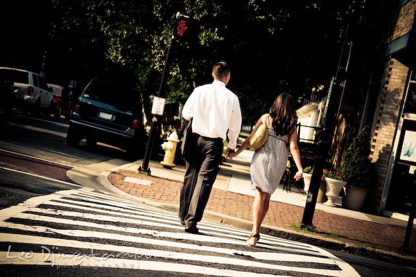 fiancee couple crossing the street. fun candid engagement prewedding photo session Old Town Alexandria VA Washington DC
