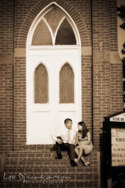 fiancee couple by an old church building. fun candid engagement prewedding photo session Old Town Alexandria VA Washington DC
