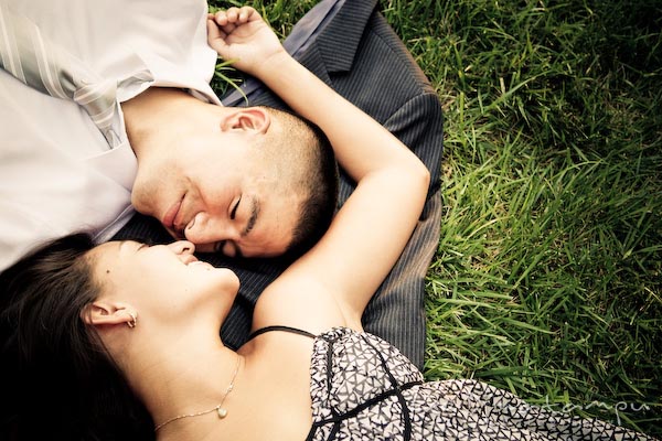 fiancee couple laying on grass. fun candid engagement prewedding photo session Old Town Alexandria VA Washington DC