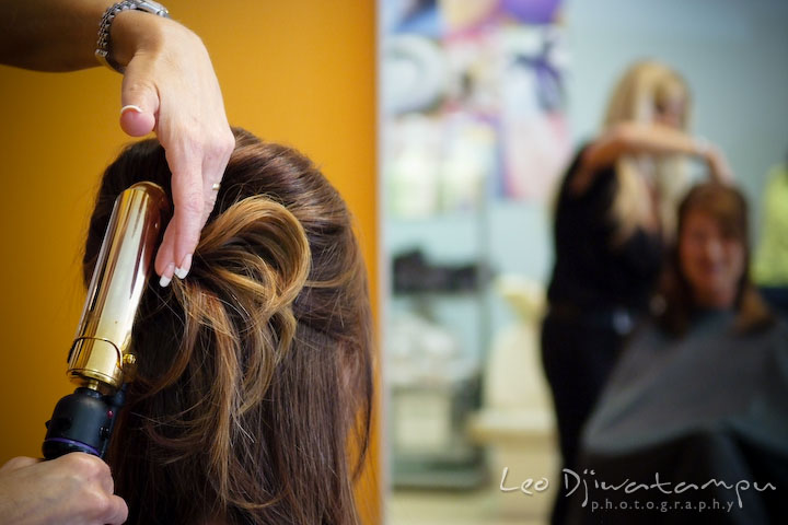 Hair dresser using curling iron on mother of groom's hair. Stafford Virginia Wedding Photographer