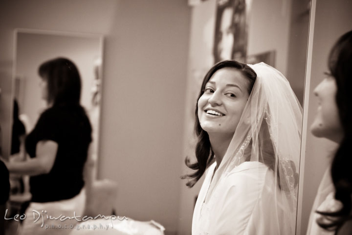 Bride admiring her make up in front of the mirror. Stafford Virginia Wedding Photographer