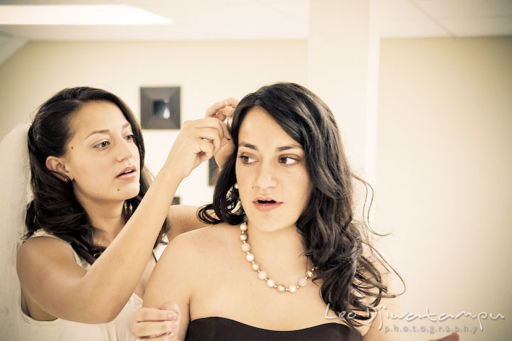Bride helping maid of honor with her hair. Stafford Virginia Wedding Photographer