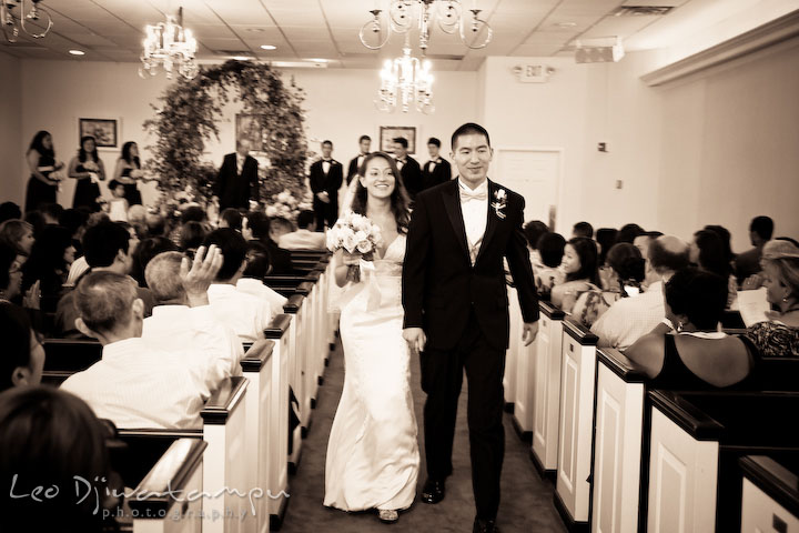 Bride and groom walks up the isle during recessional. Stafford Virginia Wedding Photographer