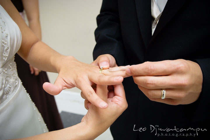 Groom looking at bride's wedding and engagement ring. Stafford Virginia Wedding Photographer